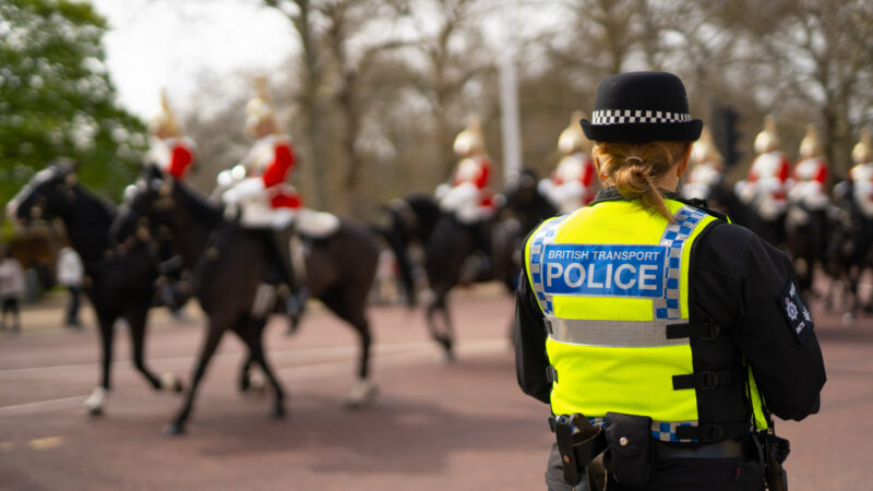 Police officer with military march in the background